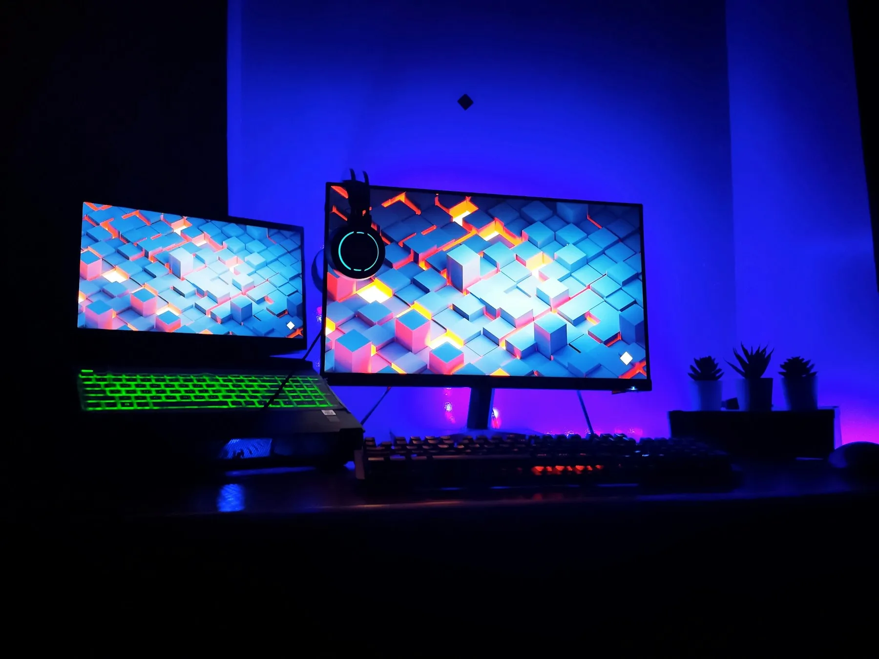 Two monitors in a dark gaming setup