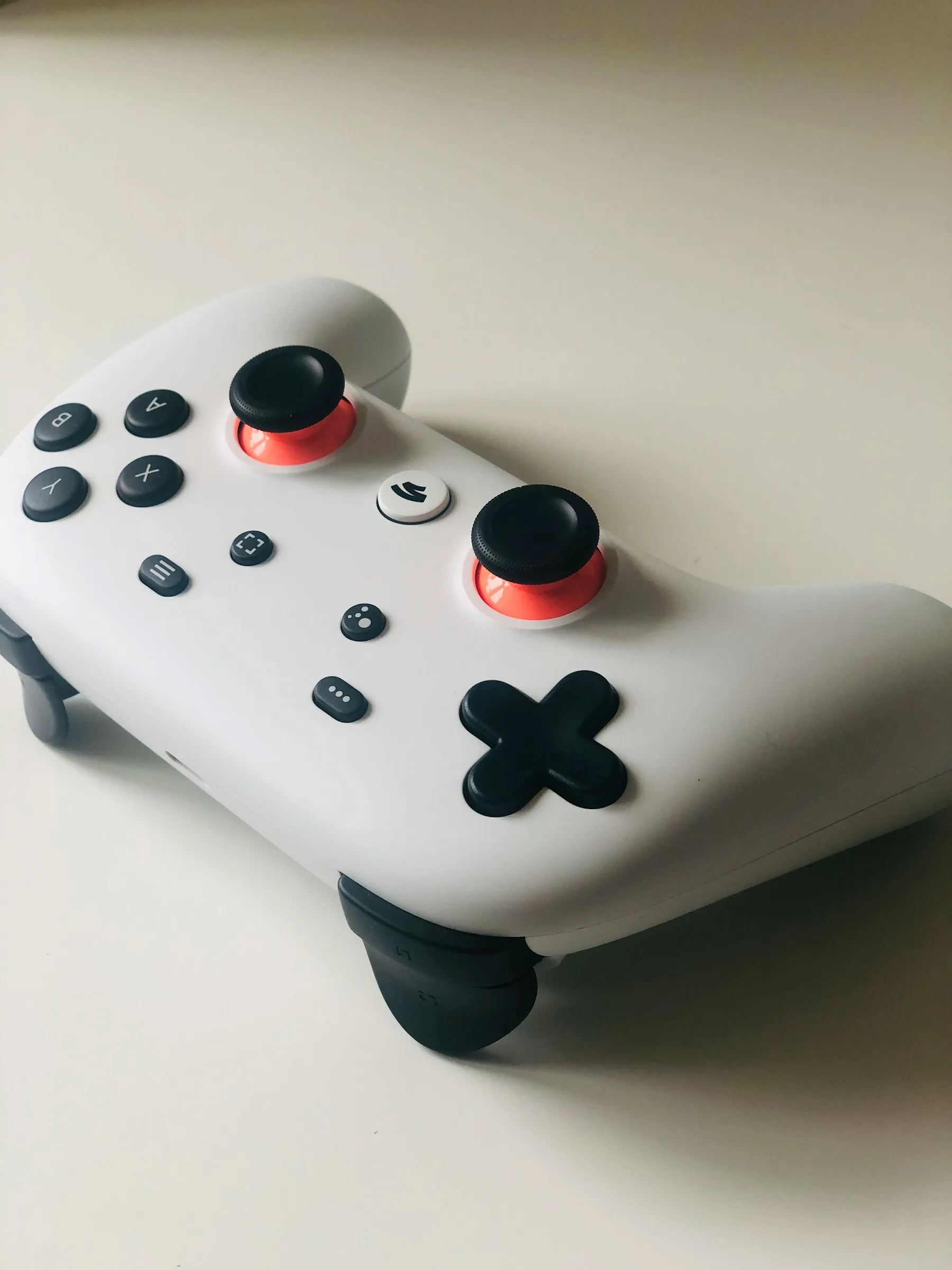 A white game controller resting on a table