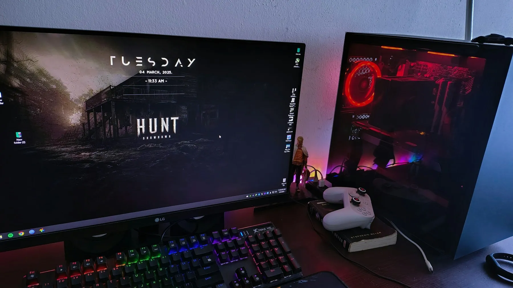 A red-lit gaming desk with a monitor and computer
